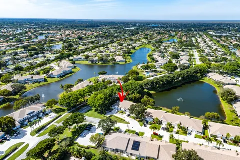 an aerial view of a house with a yard basket ball court and parked