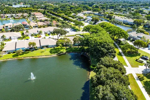 a view of a tennis ground with large trees
