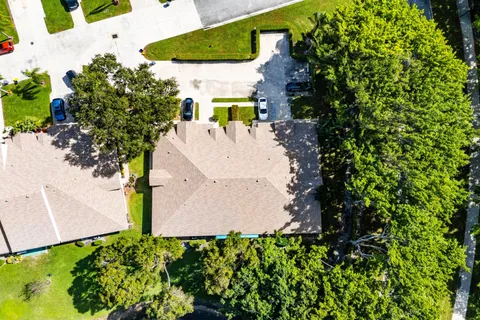 an aerial view of residential houses with outdoor space and swimming pool