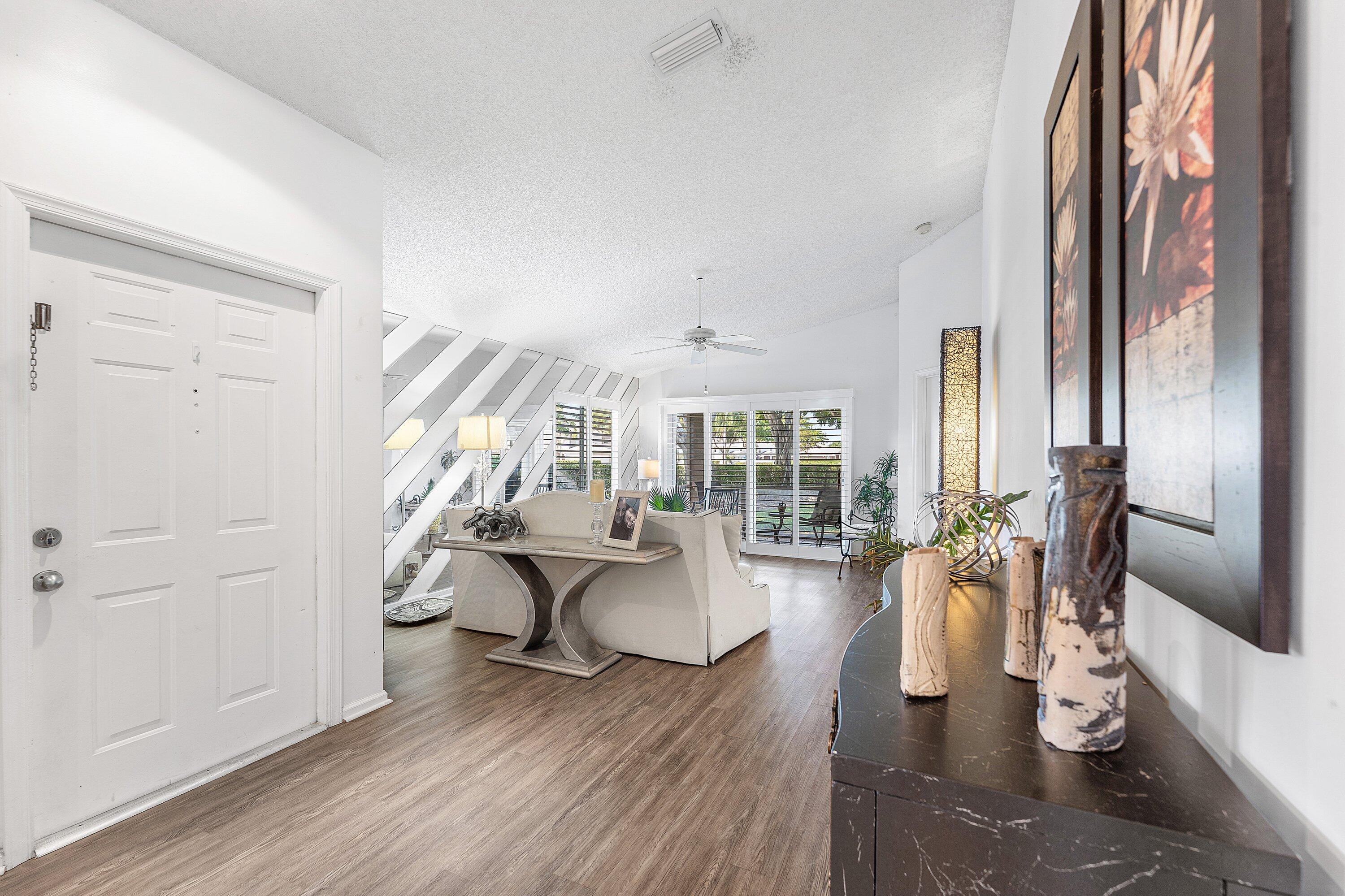9112 Vineland Court, Unit A Boca Raton, FL 33496 - Photo 6 of 62 a living room with furniture and wooden floor