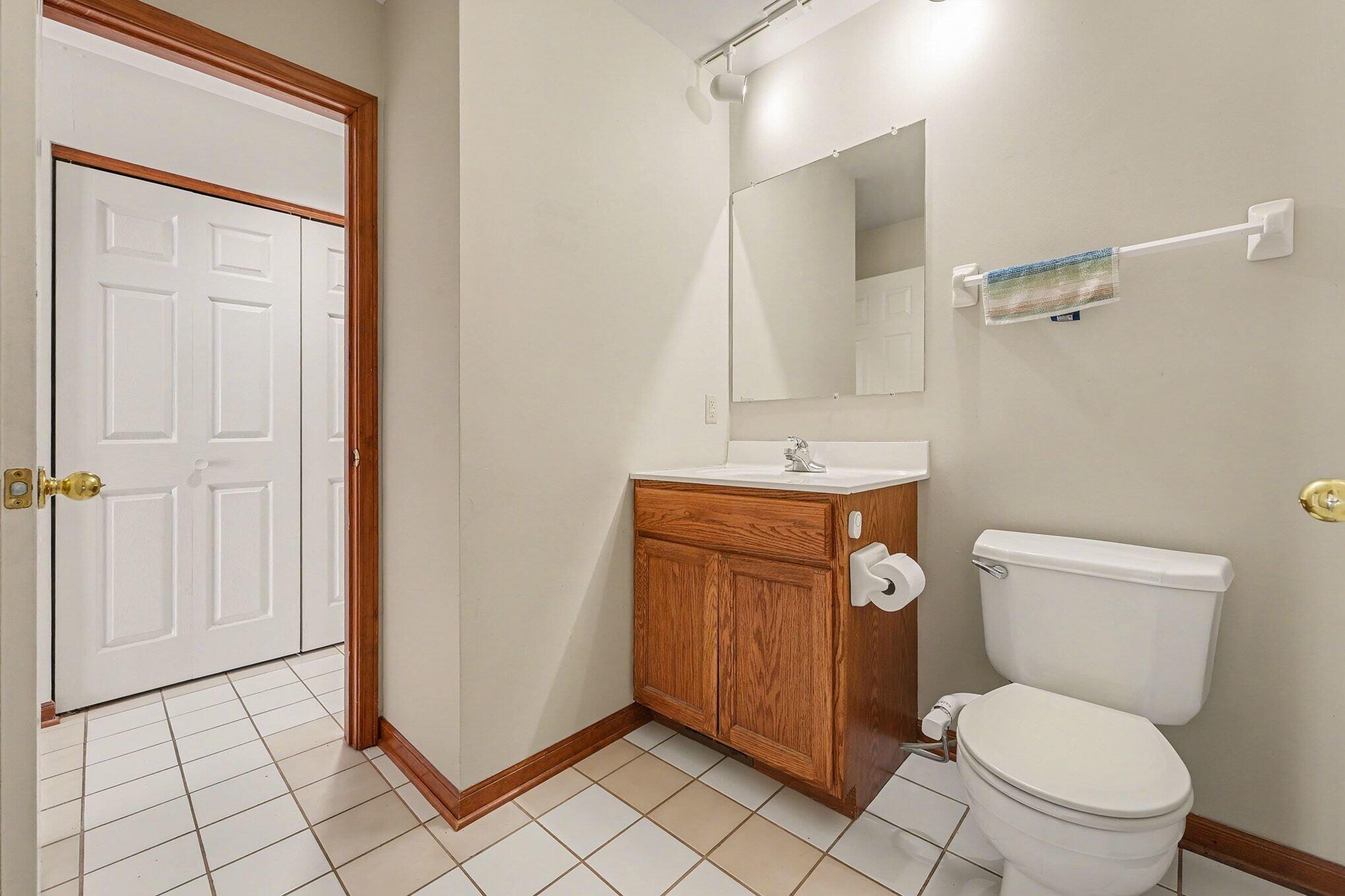 1341 West 94th Court Crown Point, IN 46307 - Photo 12 of 38 a white toilet sitting next to a bathroom sink