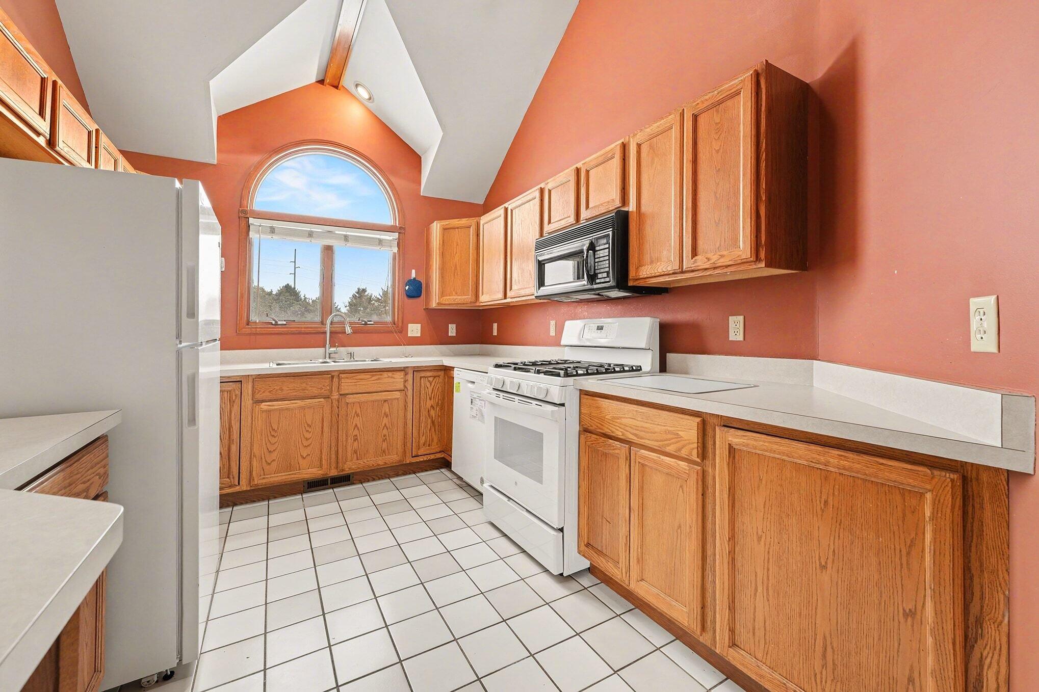 1341 West 94th Court Crown Point, IN 46307 - Photo 16 of 38 a kitchen with stainless steel appliances a stove sink and cabinets