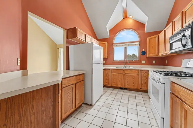 a kitchen with stainless steel appliances a stove a sink and a refrigerator