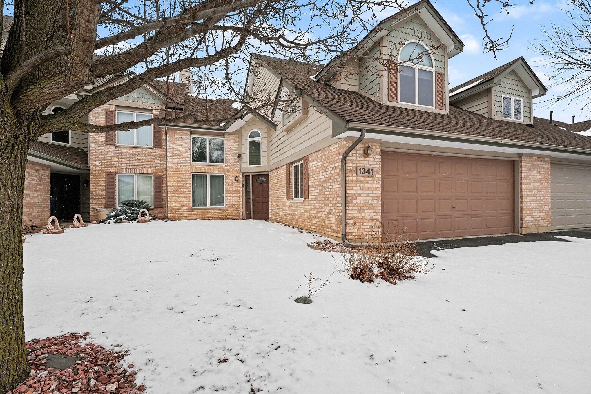 1341 West 94th Court Crown Point, IN 46307 - Photo 4 of 38 a front view of a house with a yard covered in snow