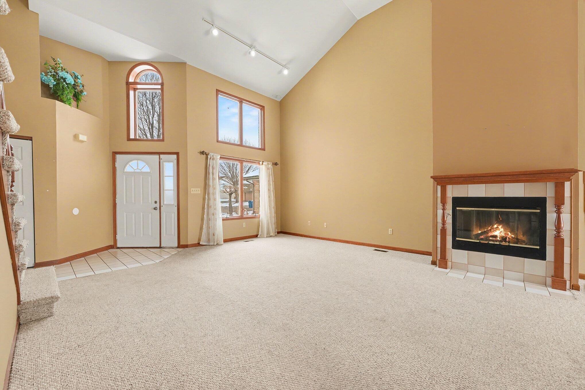 1341 West 94th Court Crown Point, IN 46307 - Photo 8 of 38 a view of an empty room with a fireplace and a window