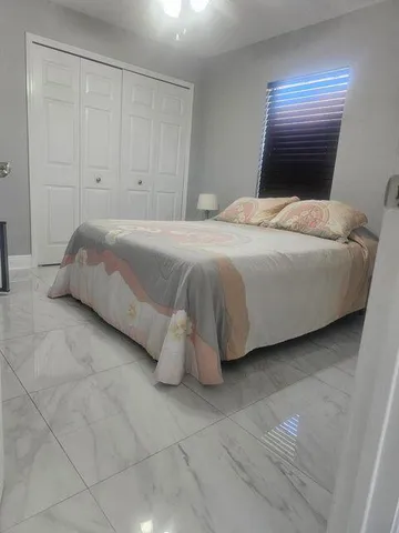 a bedroom with a bed and a night stand