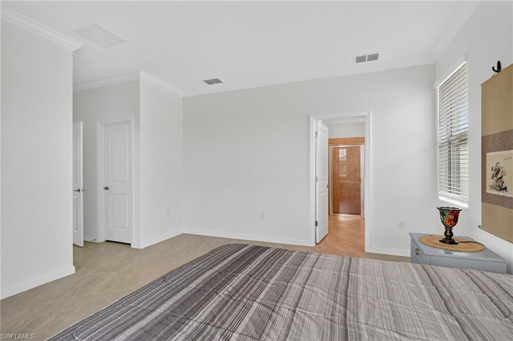 2126 Hamlin Street Naples, FL 34120 - Photo 12 of 38 a view of a room with wooden floor and bathroom