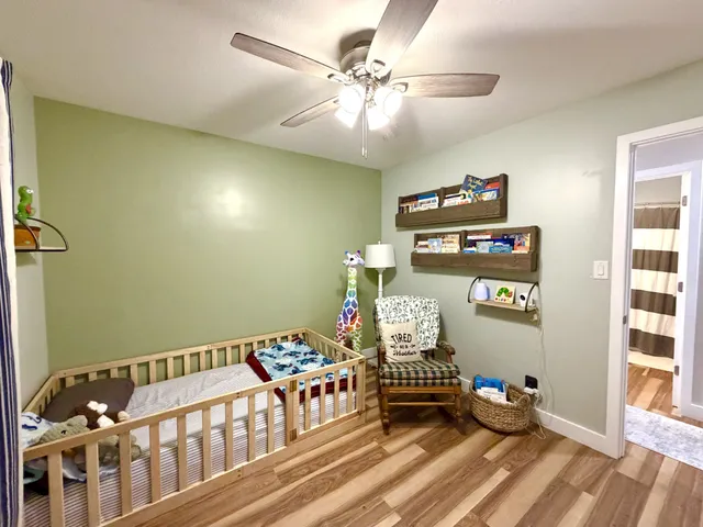 a bedroom with furniture and wooden floor