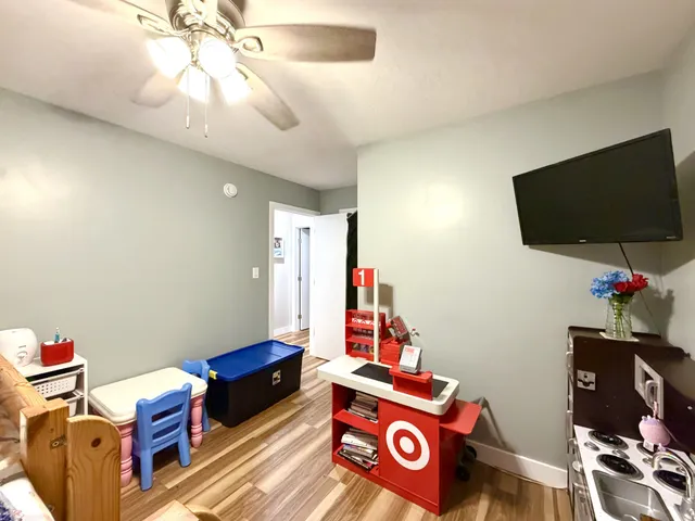 a view of a workspace with furniture and a flat screen tv