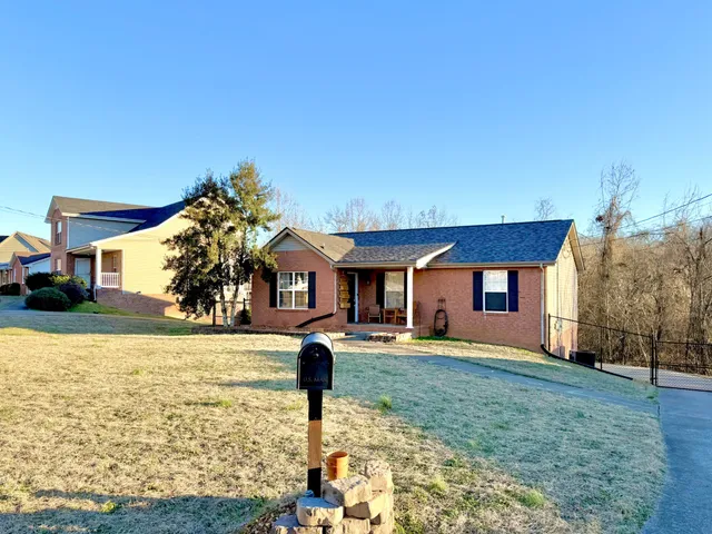 a front view of house with yard and trees