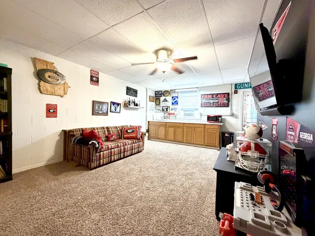 a living room with lots of furniture and flat screen tv
