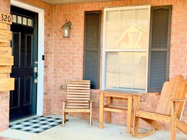 a view of front door of house with stairs