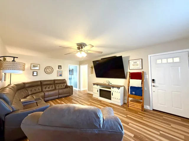a spacious bedroom with a bed and a flat screen tv