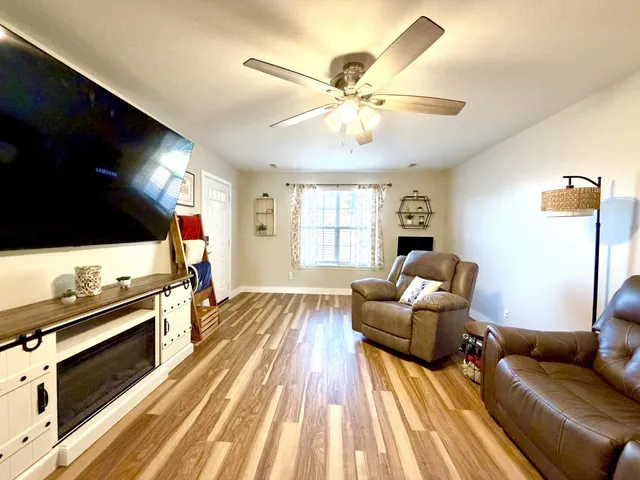 a living room with furniture and a flat screen tv