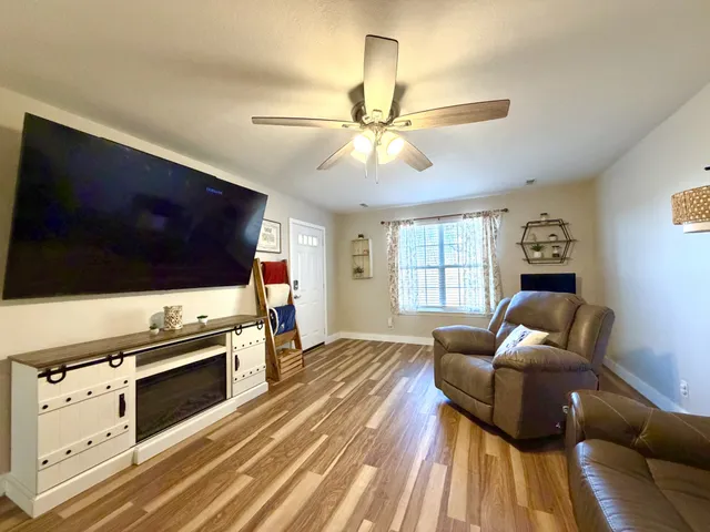 a living room with furniture and a flat screen tv