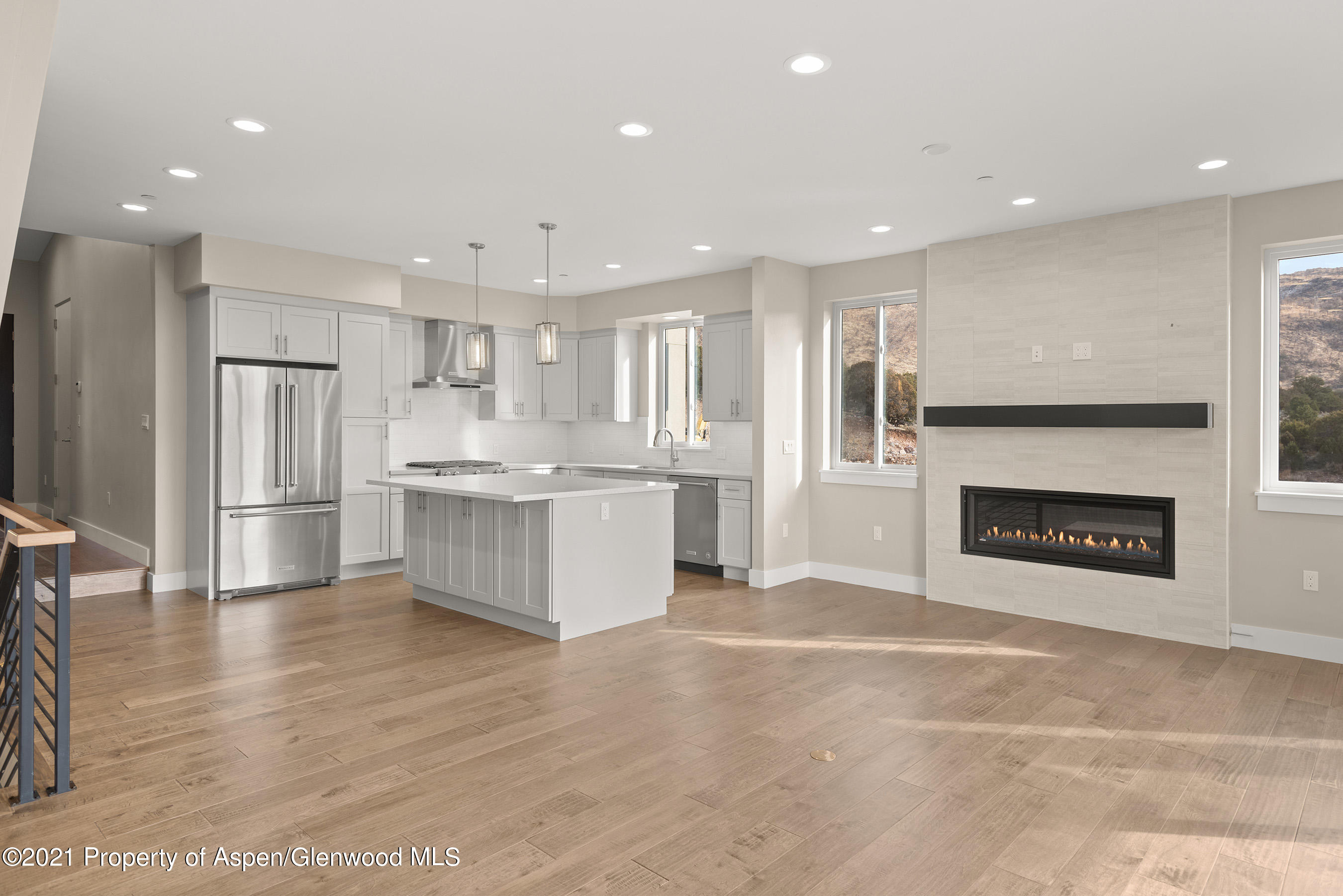 264 Overlook Ridge Carbondale, CO 81623 - Photo 19 of 39 a large kitchen with a stove a refrigerator a sink and a fireplace
