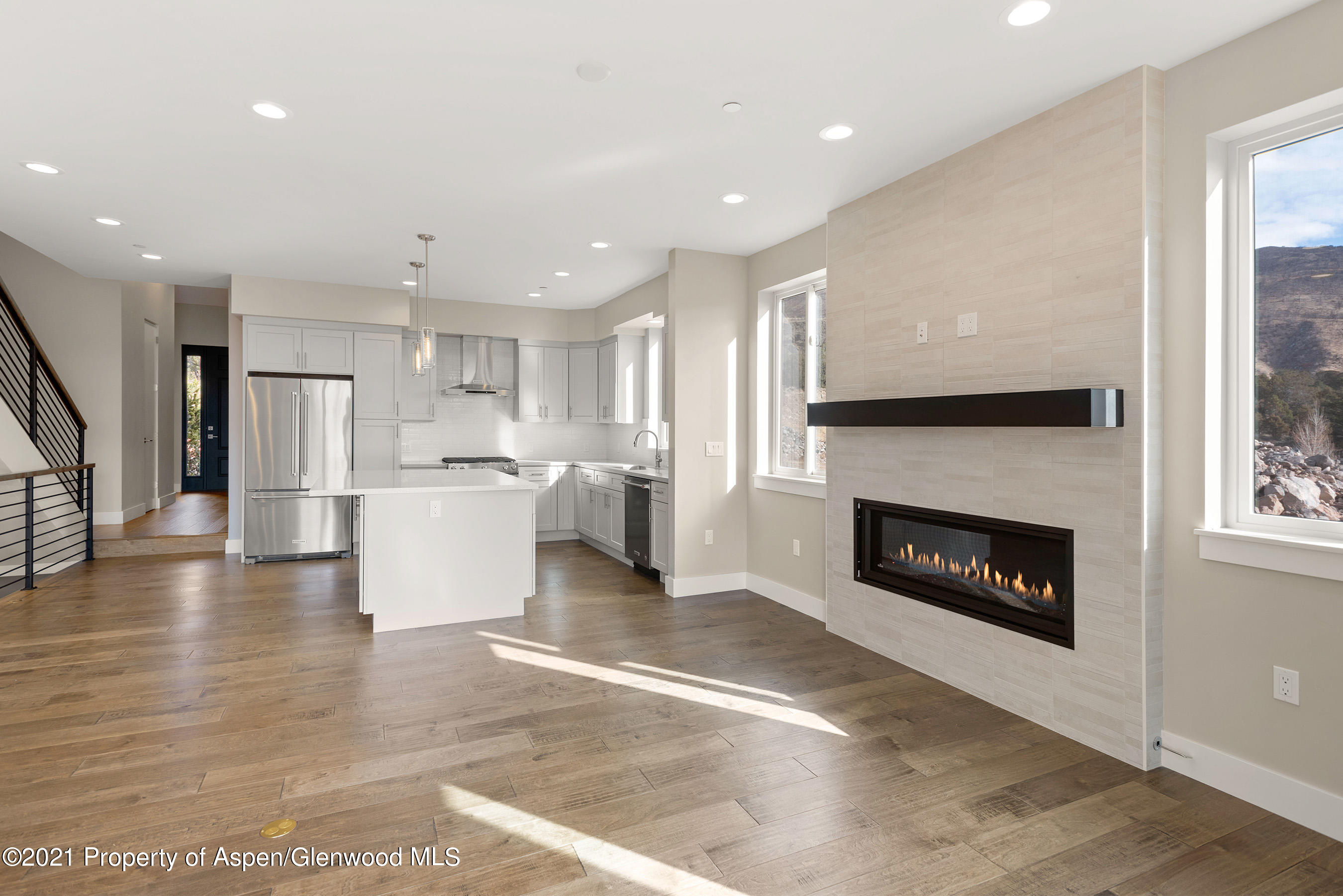 264 Overlook Ridge Carbondale, CO 81623 - Photo 20 of 39 a living room with stainless steel appliances furniture a fireplace and a kitchen view