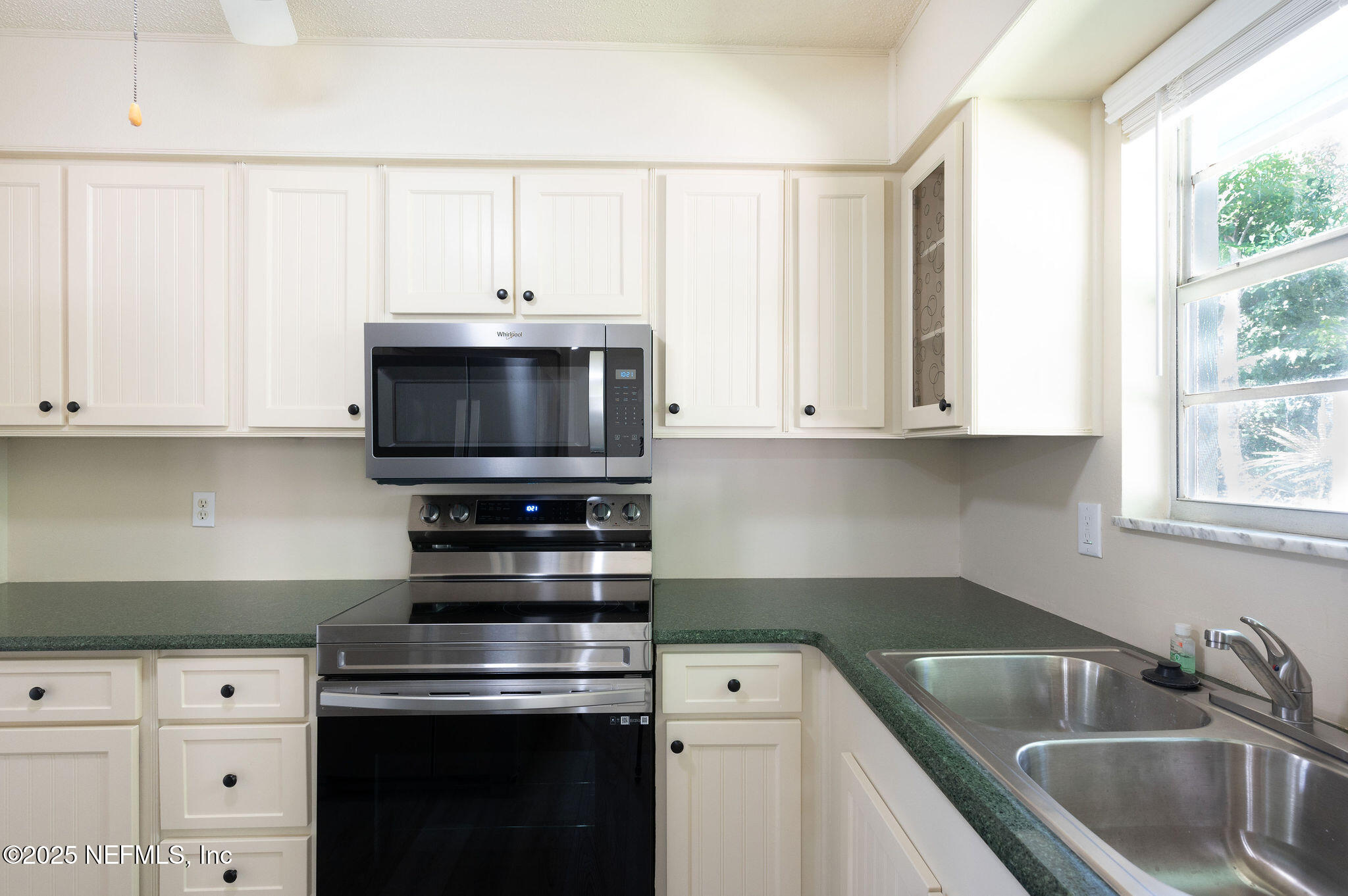 63 Hernandez Avenue Ormond Beach, FL 32174 - Photo 11 of 33 a kitchen with appliances a sink and cabinets