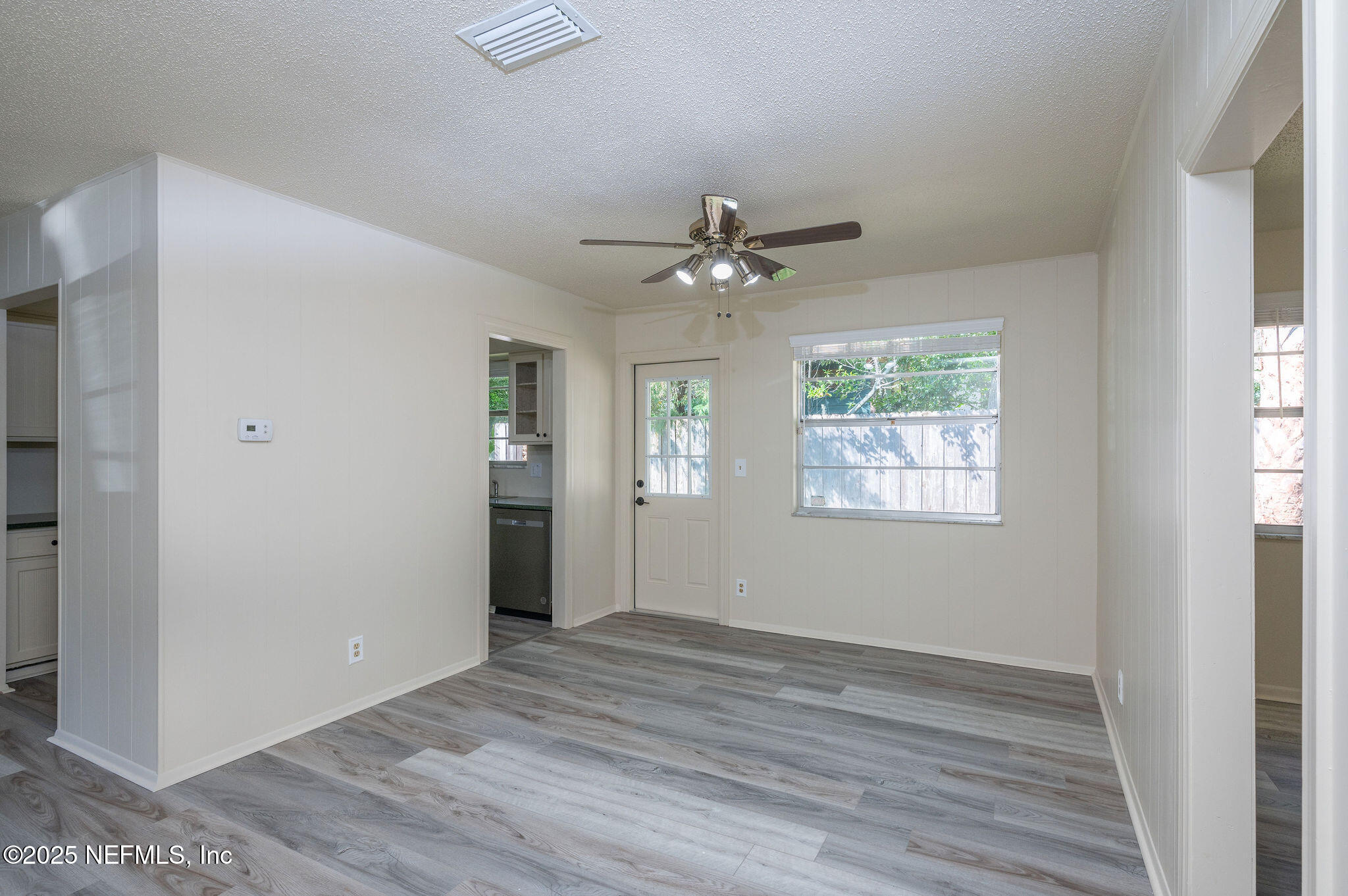 63 Hernandez Avenue Ormond Beach, FL 32174 - Photo 12 of 33 wooden floor in an empty room with a window