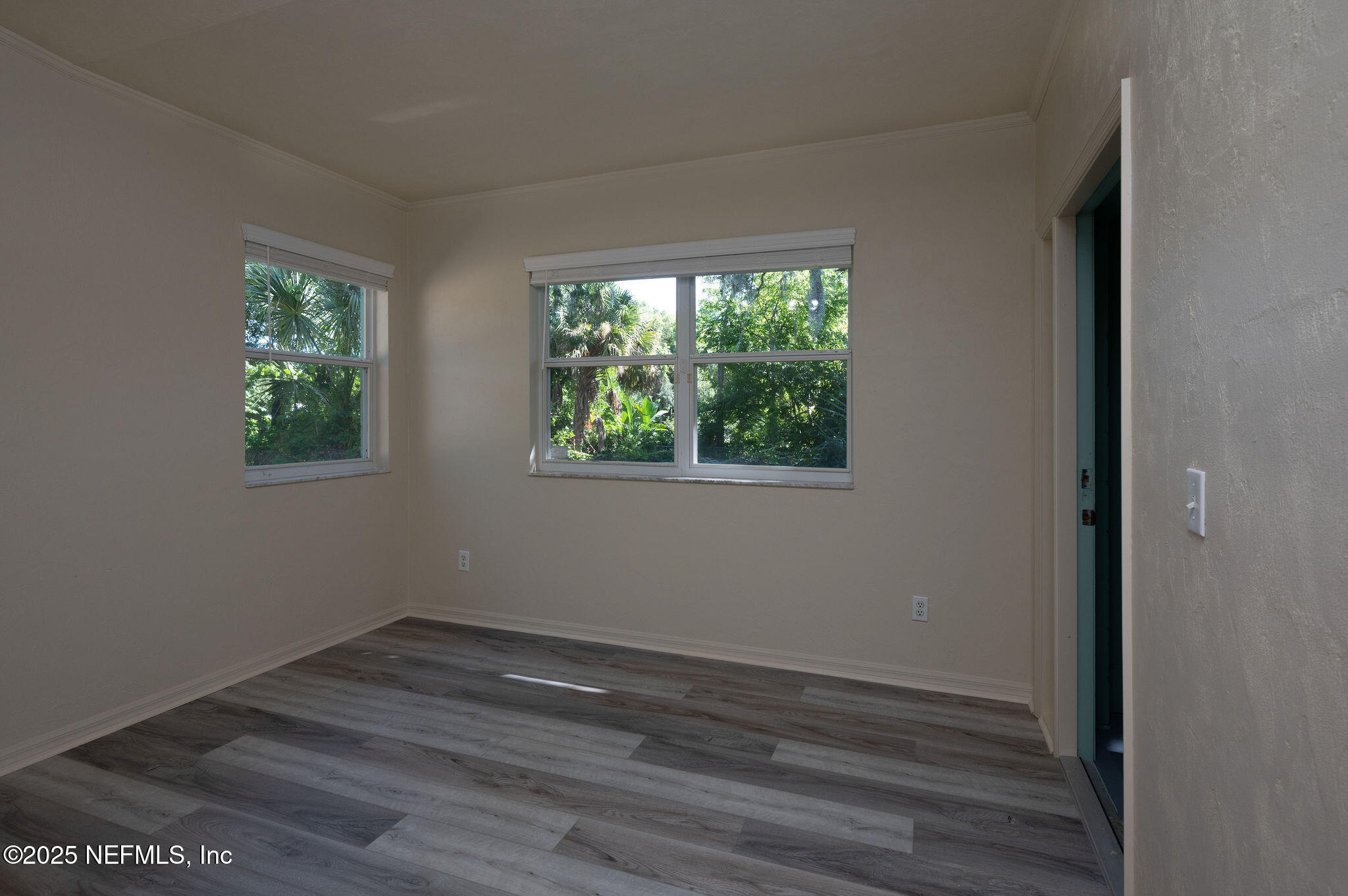 63 Hernandez Avenue Ormond Beach, FL 32174 - Photo 26 of 33 a view of empty room with wooden floor and fan