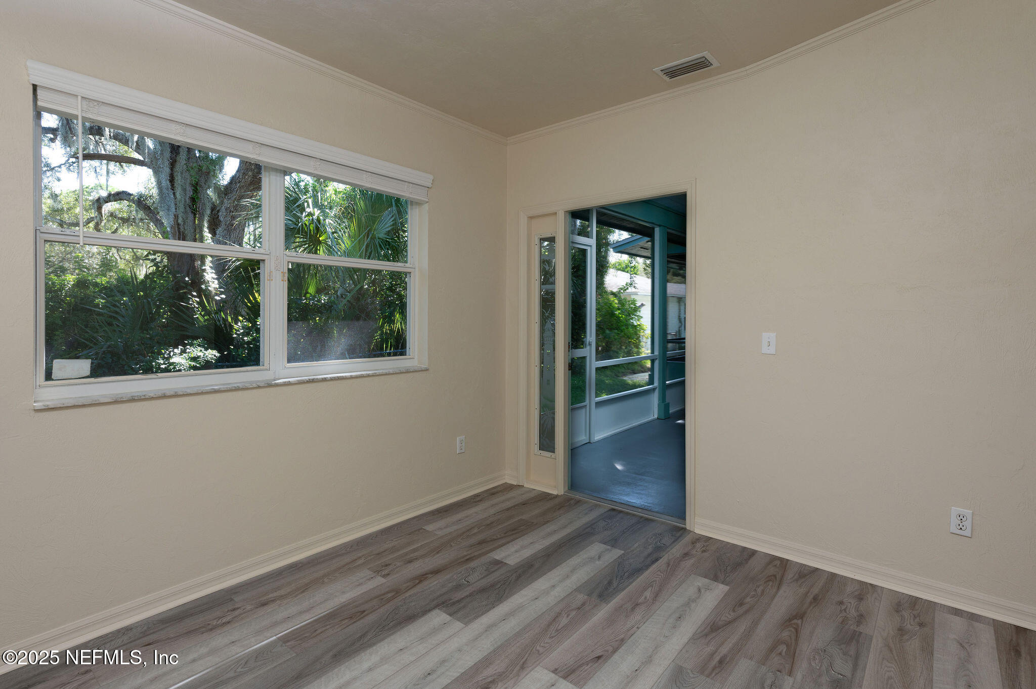 63 Hernandez Avenue Ormond Beach, FL 32174 - Photo 28 of 33 a view of empty room with wooden floor and fan
