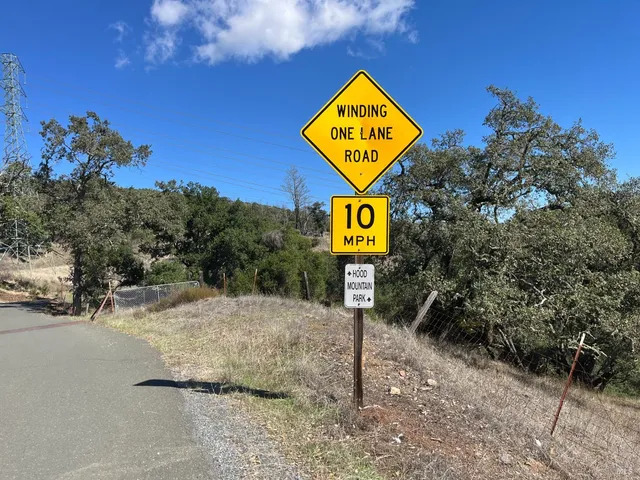 a street sign on a pole on a road