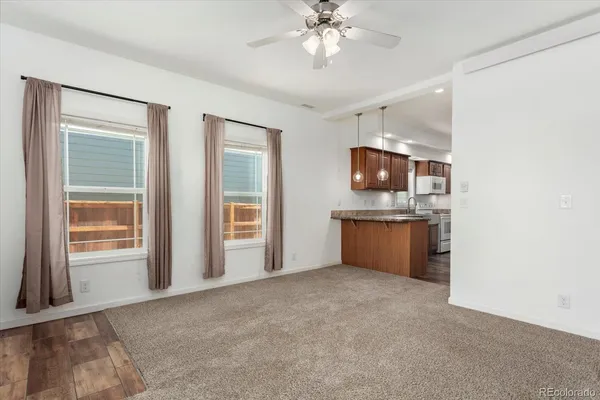 a view of kitchen with granite countertop cabinets and window