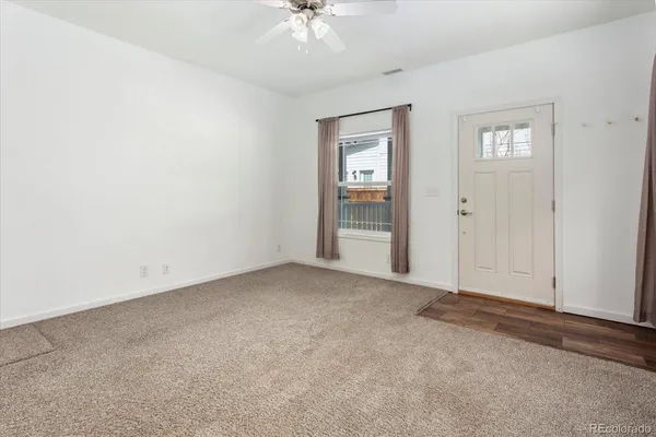an empty room with windows and closet