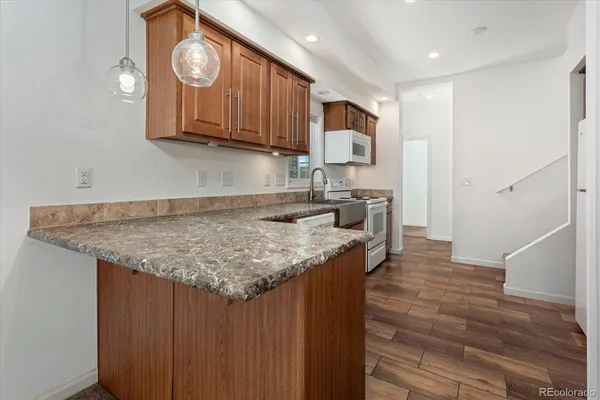 a kitchen with cabinets and wooden floor