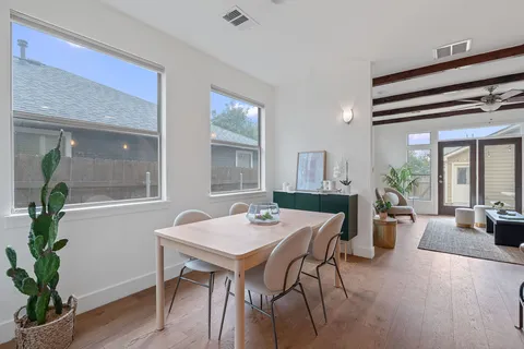 a view of a dining room with furniture window and wooden floor