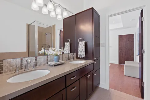 a bathroom with a double vanity sink and a mirror