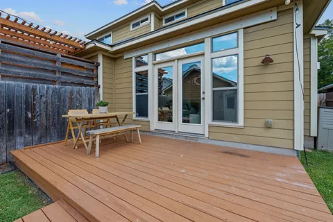 a white bench sitting in front of a house