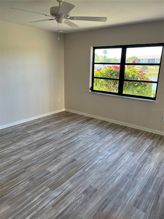 175 Kings Highway, Unit 1018 Punta Gorda, FL 33983 - Photo 12 of 35 wooden floor in an empty room with a window
