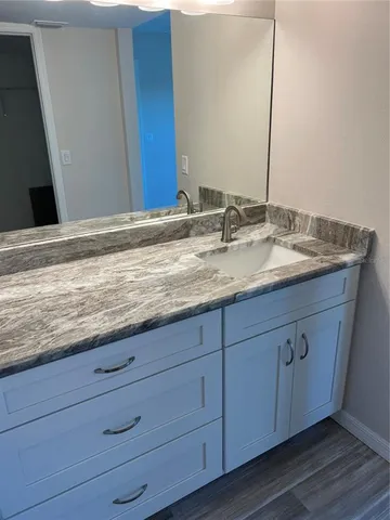 a bathroom with a sink and a mirror