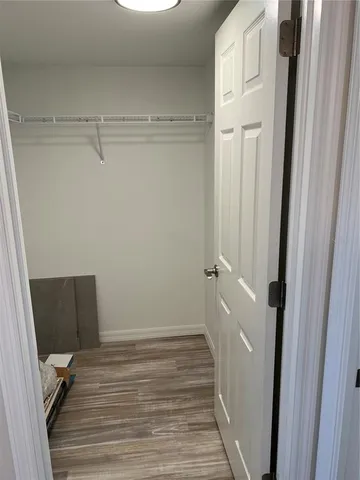a view of a room with wooden floor and bathroom