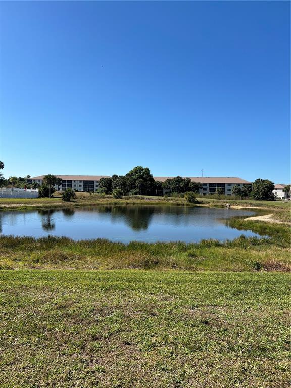 175 Kings Highway, Unit 1018 Punta Gorda, FL 33983 - Photo 22 of 35 a view of a lake with houses in the back