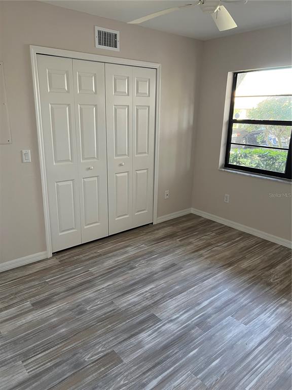 175 Kings Highway, Unit 1018 Punta Gorda, FL 33983 - Photo 23 of 35 a view of an empty room with wooden floor and a window