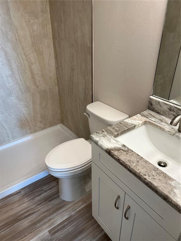 175 Kings Highway, Unit 1018 Punta Gorda, FL 33983 - Photo 26 of 35 a bathroom with a granite countertop toilet sink and mirror