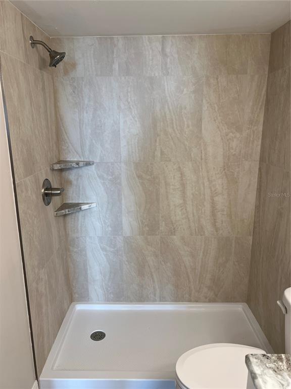 175 Kings Highway, Unit 1018 Punta Gorda, FL 33983 - Photo 28 of 35 a bathroom with a toilet and a shower