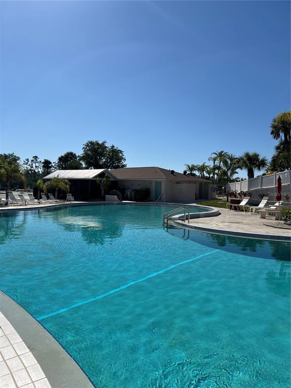175 Kings Highway, Unit 1018 Punta Gorda, FL 33983 - Photo 32 of 35 a view of a swimming pool with a yard and sitting area