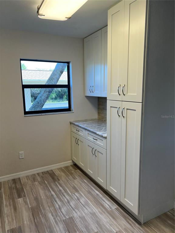 175 Kings Highway, Unit 1018 Punta Gorda, FL 33983 - Photo 9 of 35 a view of a kitchen with wooden floor and electronic appliances