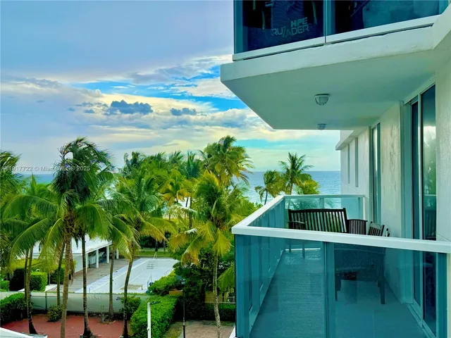 a view of a dining room with furniture large windows and wooden floor