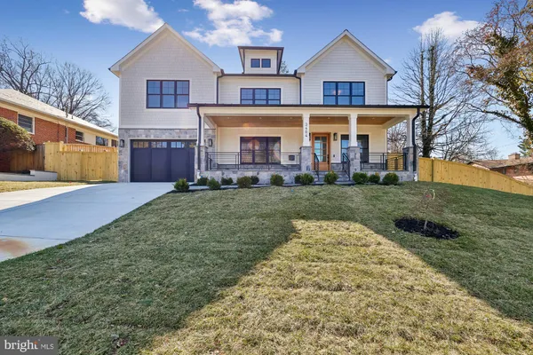 a view of a big house with a big yard and large trees