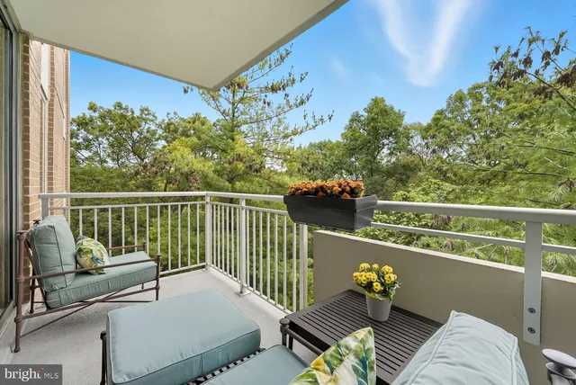 a view of a balcony with couches and wooden floor