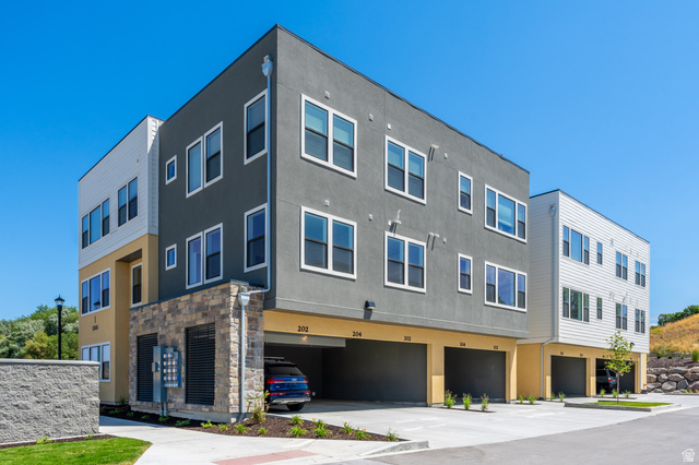 718 West Blue Magic Lane, Unit S201 Midvale, UT 84047 - Photo 15 of 18 View of building exterior featuring an attached garage