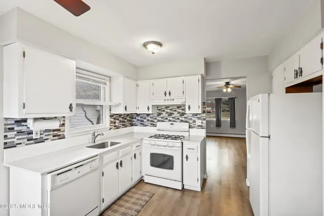a kitchen with a stove a sink and a refrigerator