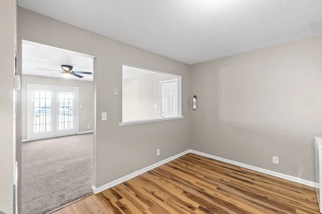 a view of a room with wooden floor and windows