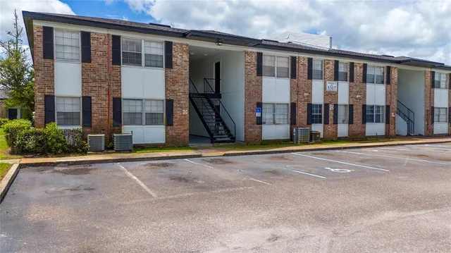 a view of a brick house with large windows