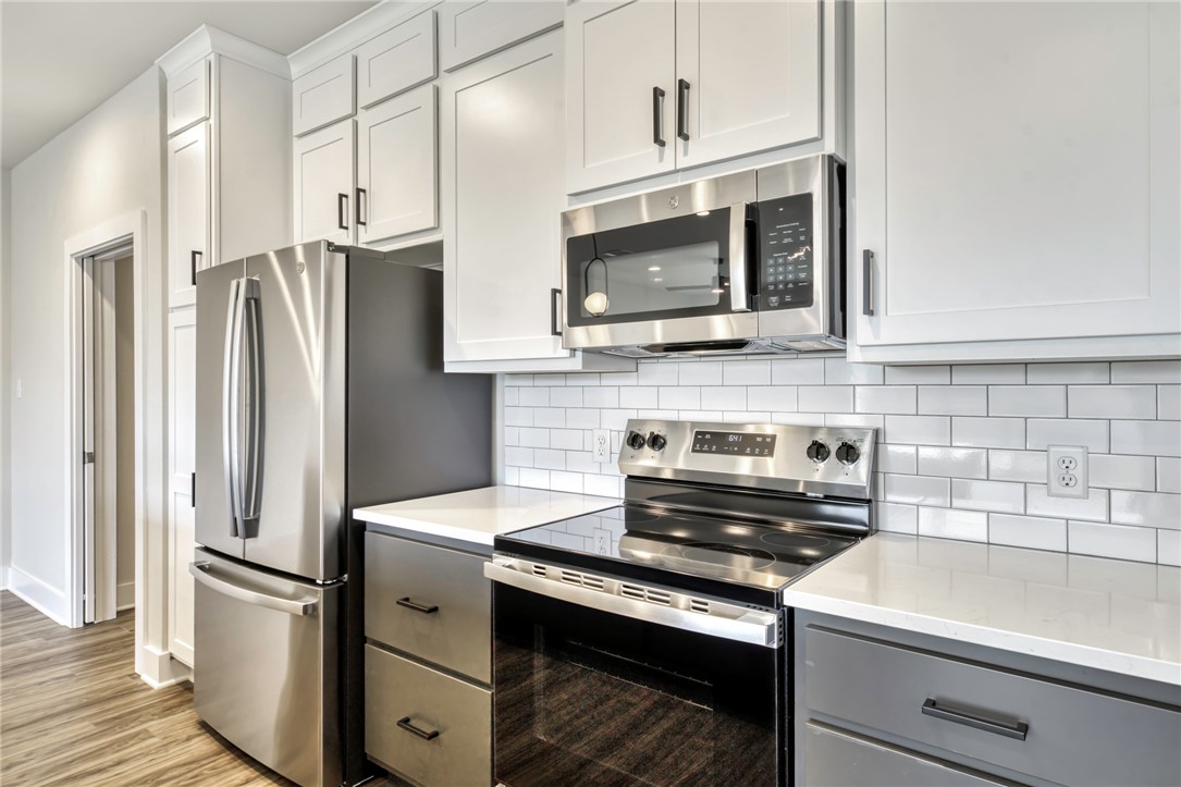 307 Cooner Street, Unit A College Station, TX 77840 - Photo 14 of 35 a kitchen with stainless steel appliances a stove microwave and refrigerator