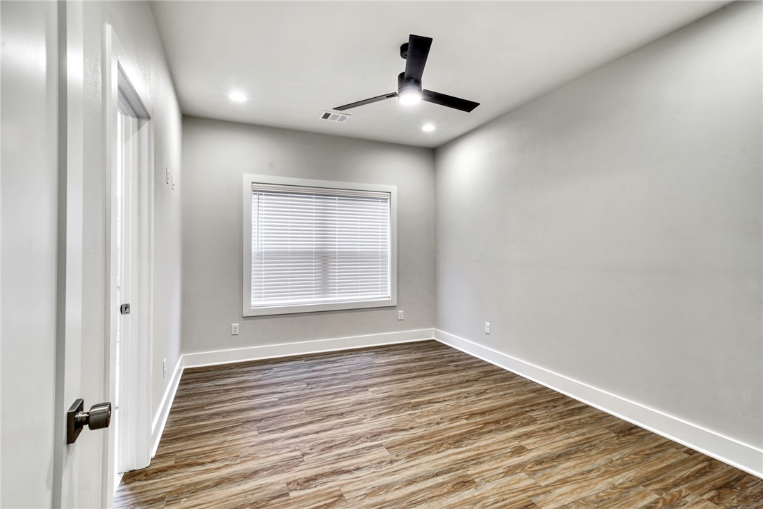 307 Cooner Street, Unit A College Station, TX 77840 - Photo 17 of 35 a view of an empty room with wooden floor and a window